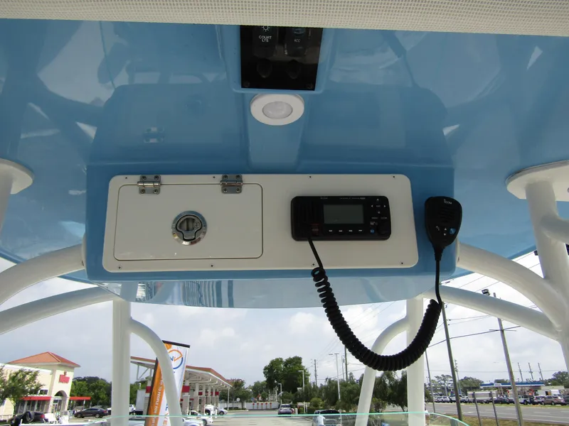 Slide: The Image of 2024 Sailfish 242 CC boat console with radio and storage compartment. - 22