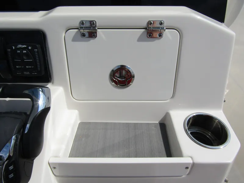 Slide: The Image of Control panel and storage compartment on 2024 Sailfish 242 CC boat. - 27