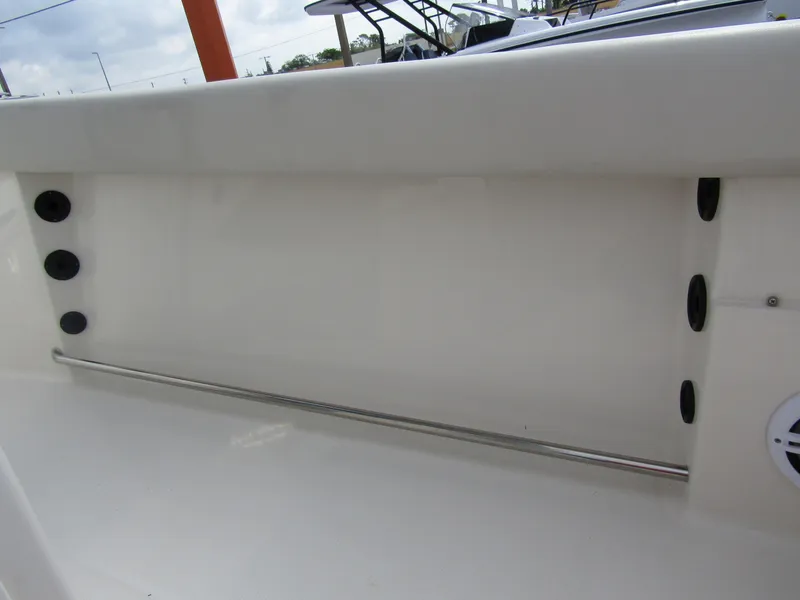 Slide: The Image of 2024 Sailfish 242 CC boat interior with rod holders and stainless steel railing. - 31