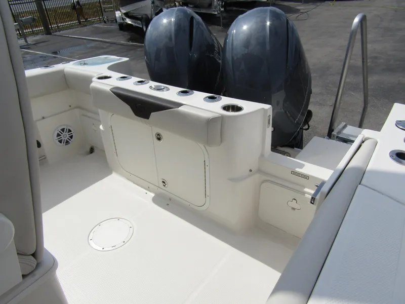 Slide: The Image of 2024 Sailfish 242 CC boat with dual outboard motors and spacious deck. - 32