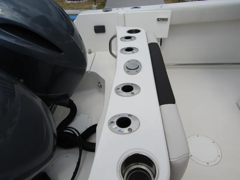 Slide: The Image of 2024 Sailfish 242 CC boat with rod holders and dual outboard engines. - 34