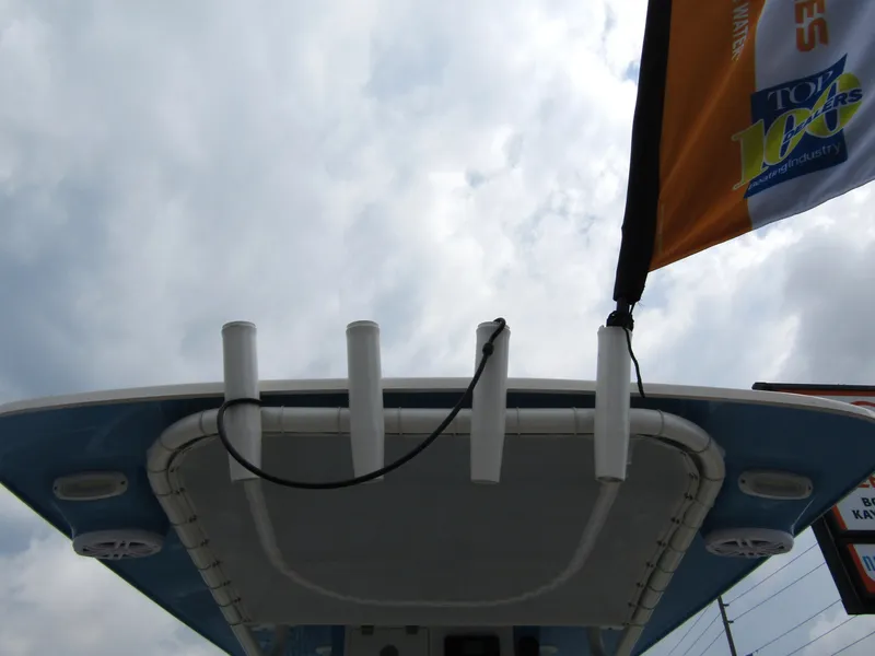 Slide: The Image of 2024 Sailfish 242 CC boat top view with rod holders and flag. - 38