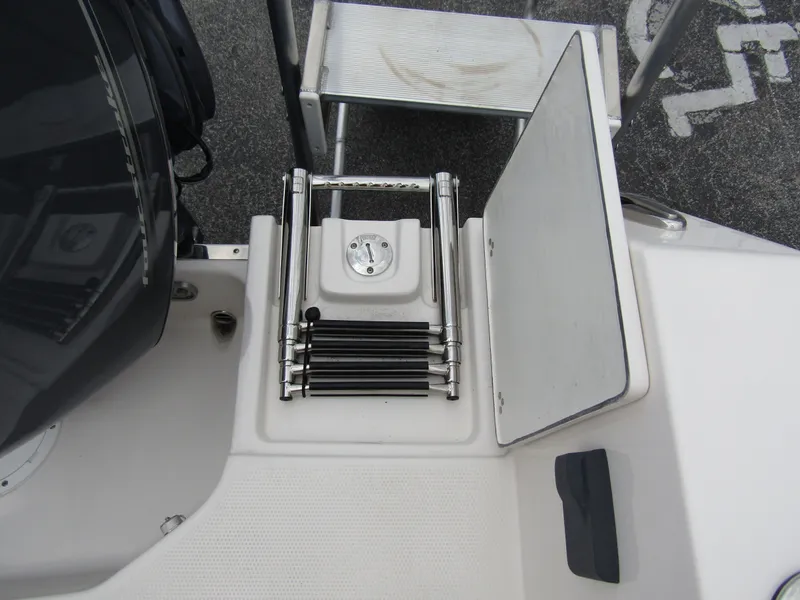 Slide: The Image of 2024 Sailfish 242 CC boat with folded swim ladder and storage compartment. - 40