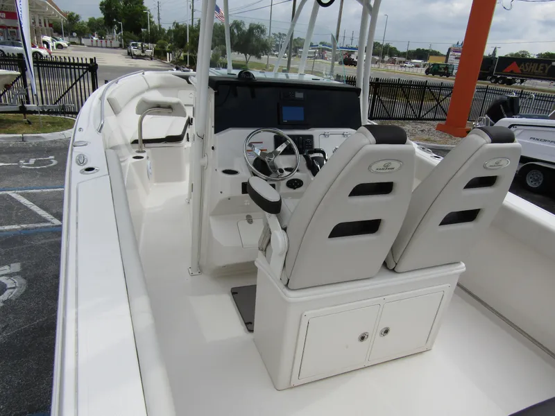 Slide: The Image of 2024 Sailfish 242 CC boat interior with dual captain's chairs and modern console. - 41