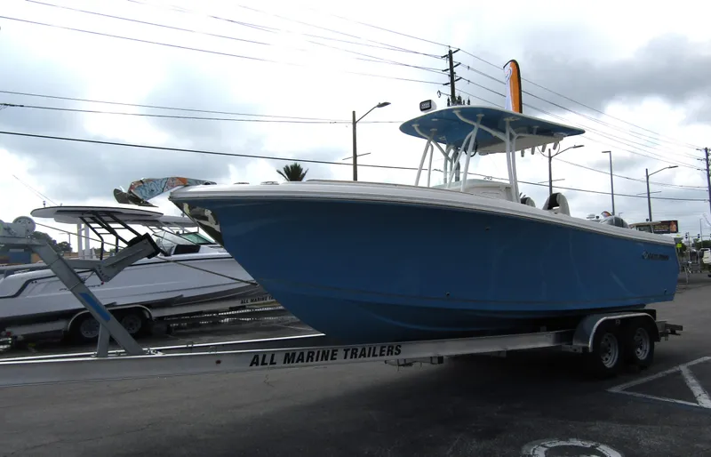 Slide: The Image of 2024 Sailfish 242 CC boat on a trailer in a parking lot. - 6