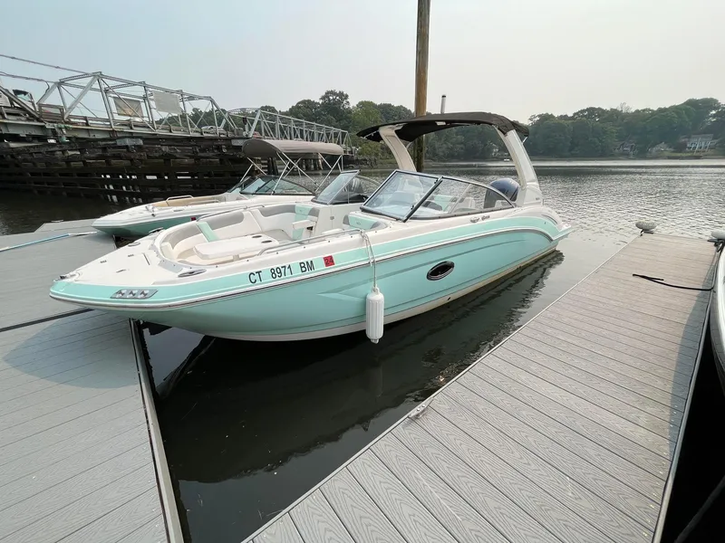 Slide: The Image of 2020 Chaparral Suncoast 250 boat docked on calm water. - 0