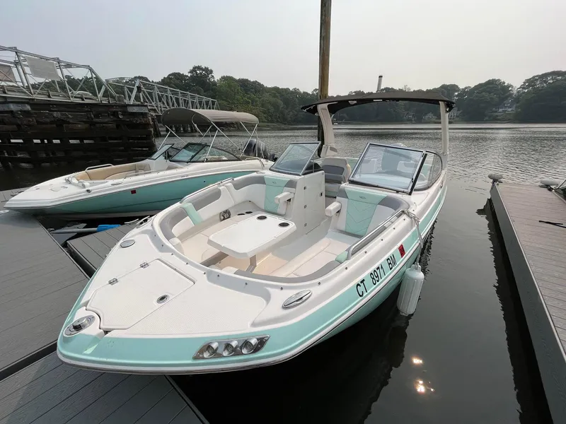 Slide: The Image of 2020 Chaparral Suncoast 250 boat docked on a calm lake. - 1