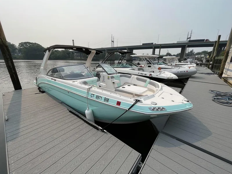 Slide: The Image of 2020 Chaparral Suncoast 250 boat docked at marina, side view. - 2
