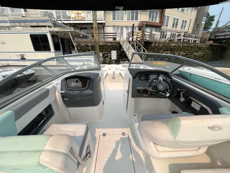 Slide: The Image of 2020 Chaparral Suncoast 250 boat interior with dual seating and steering console. - 4