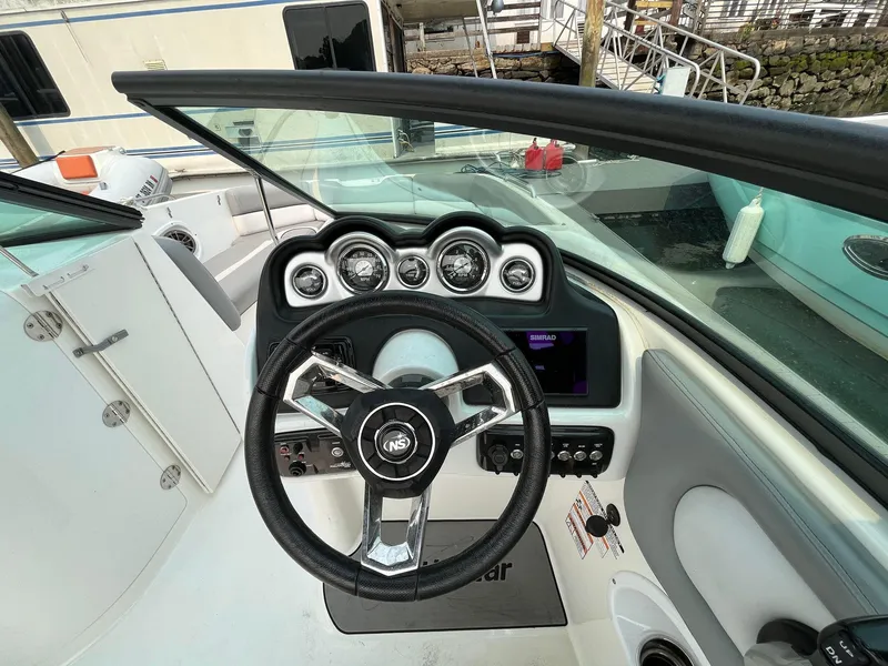 Slide: The Image of 2020 Chaparral Suncoast 250 boat dashboard with steering wheel and gauges. - 5