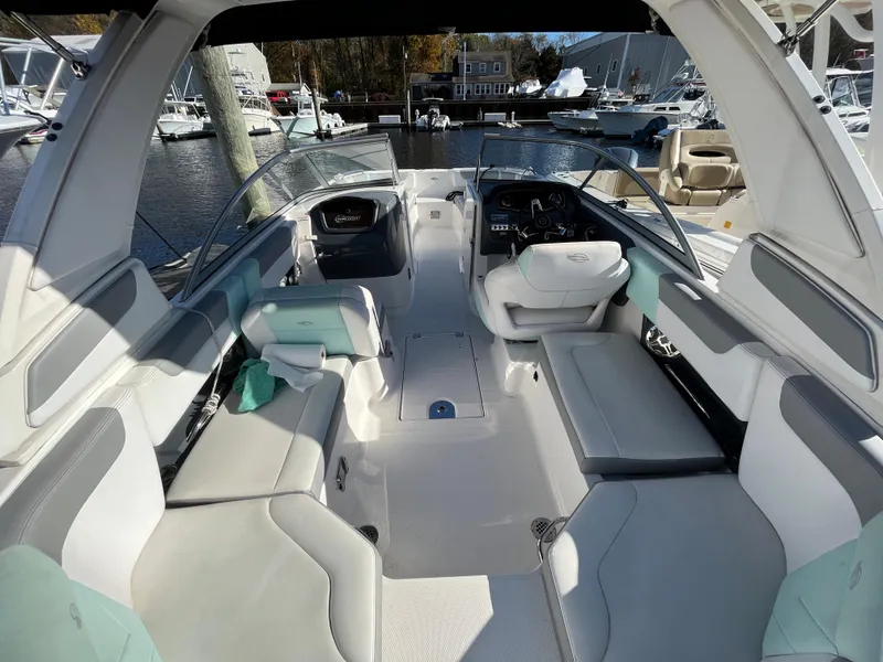 Slide: The Image of 2020 Chaparral Suncoast 250 boat interior with spacious seating and modern dashboard. - 6