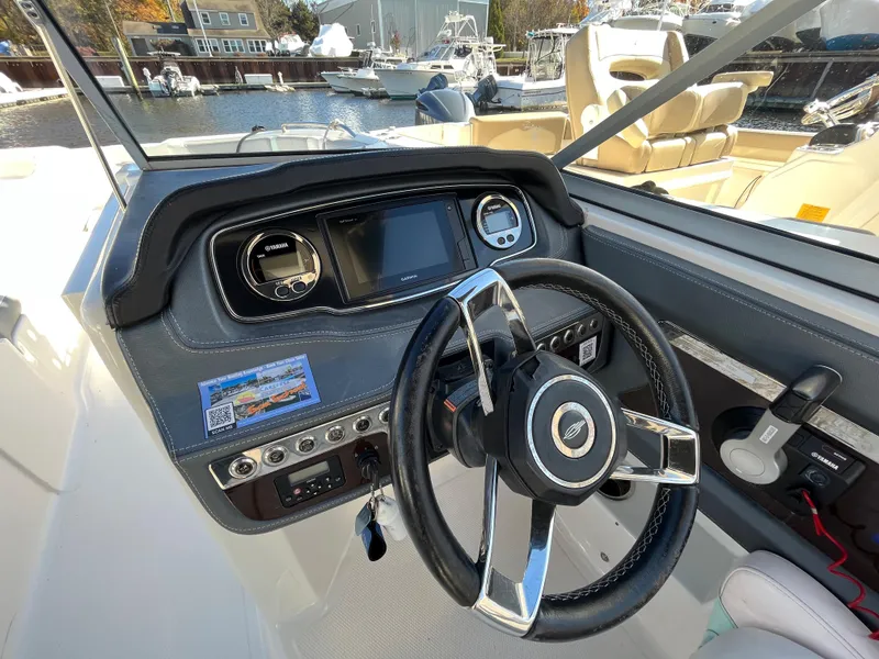 Slide: The Image of 2020 Chaparral Suncoast 250 boat dashboard with steering wheel and control panel. - 8