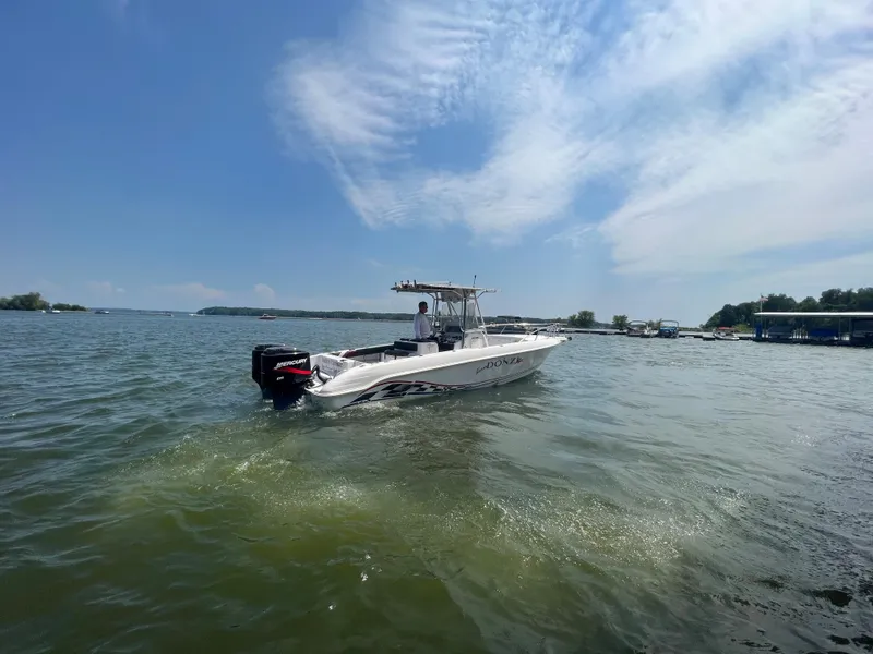 Slide: The Image of 1999 Donzi 30 ZF boat cruising on a sunny lake. - 10