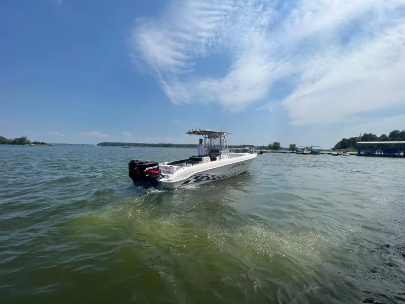 Slide: The Image of 1999 Donzi 30 ZF boat cruising on a sunny lake. - 11