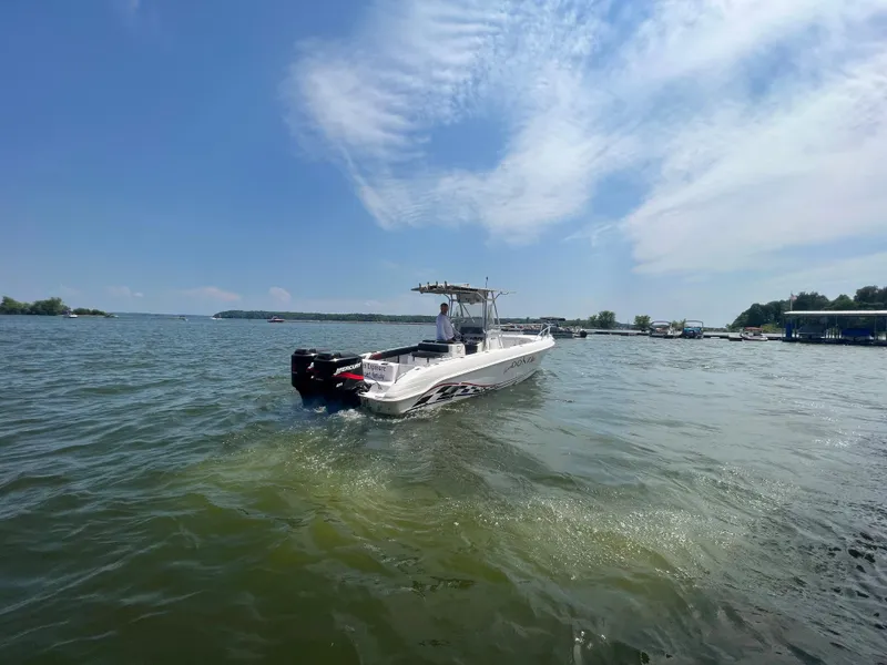 Slide: The Image of 1999 Donzi 30 ZF boat cruising on a sunny lake. - 13