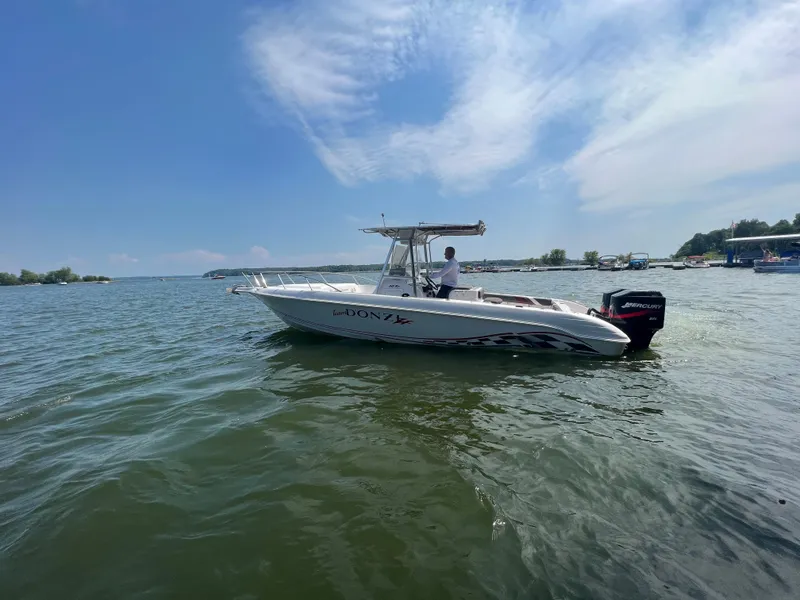 Slide: The Image of 1999 Donzi 30 ZF boat on a calm lake under a clear sky. - 17