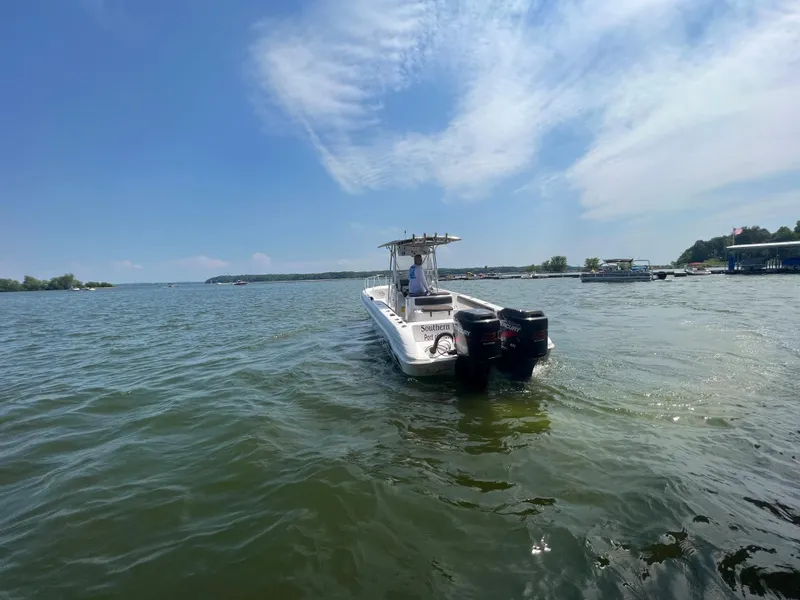 Slide: The Image of 1999 Donzi 30 ZF boat on a lake with twin outboard motors. - 20