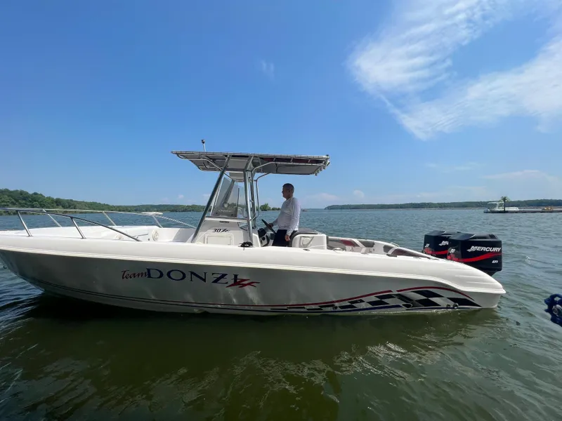 Slide: The Image of 1999 Donzi 30 ZF boat on water with person at helm. - 22