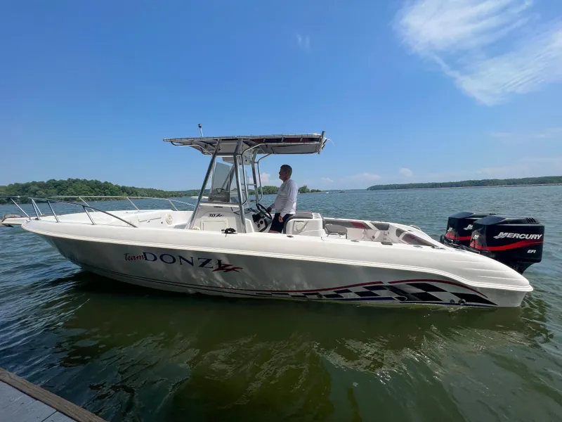 Slide: The Image of 1999 Donzi 30 ZF boat on water with Mercury outboard motor. - 23