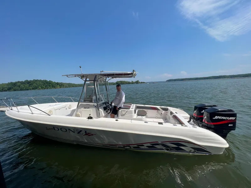 Slide: The Image of 1999 Donzi 30 ZF boat on a lake with Mercury outboard motor. - 24