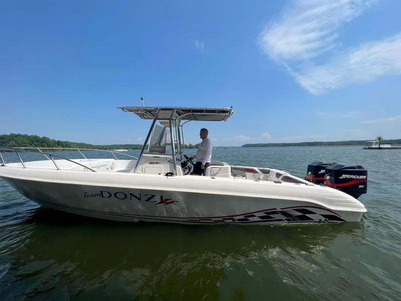 Slide: The Image of 1999 Donzi 30 ZF boat on water with Mercury outboard engines. - 25