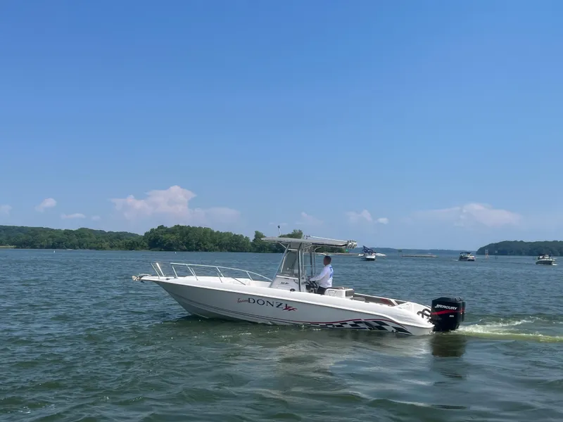 Slide: The Image of 1999 Donzi 30 ZF boat cruising on a sunny lake. - 26