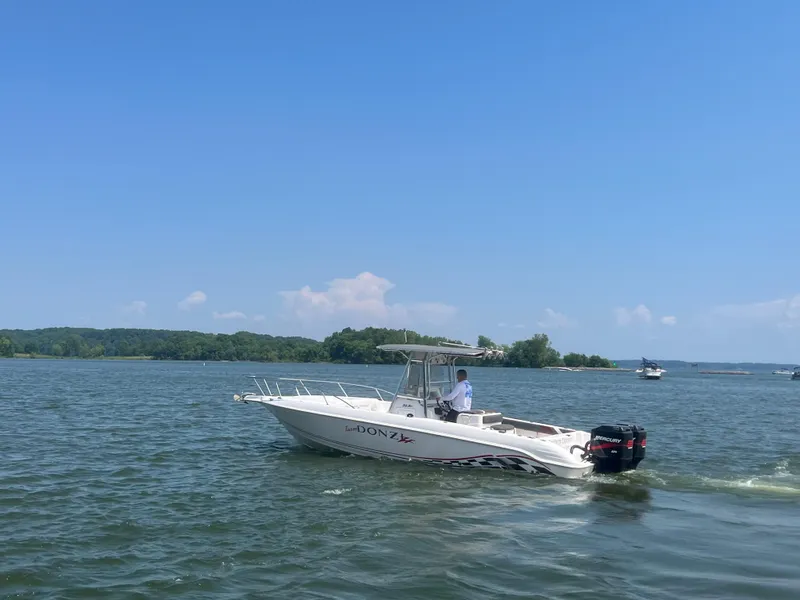 Slide: The Image of 1999 Donzi 30 ZF boat cruising on a sunny lake. - 27