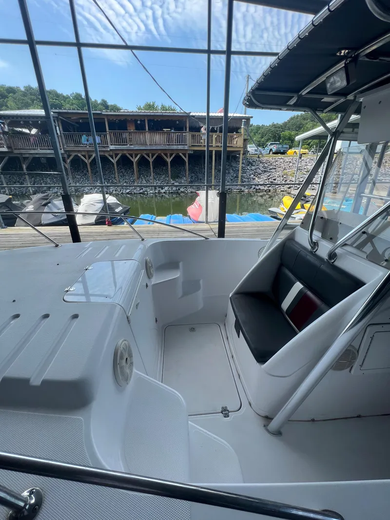 Slide: The Image of 1999 Donzi 30 ZF boat interior with seating and dock view. - 29