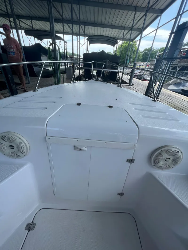 Slide: The Image of 1999 Donzi 30 ZF boat docked under a covered marina. - 32