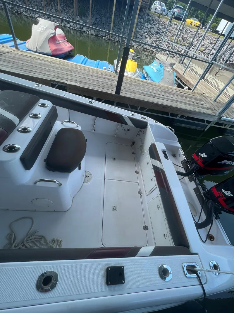 Slide: The Image of 1999 Donzi 30 ZF boat docked, showing interior seating and deck layout. - 35