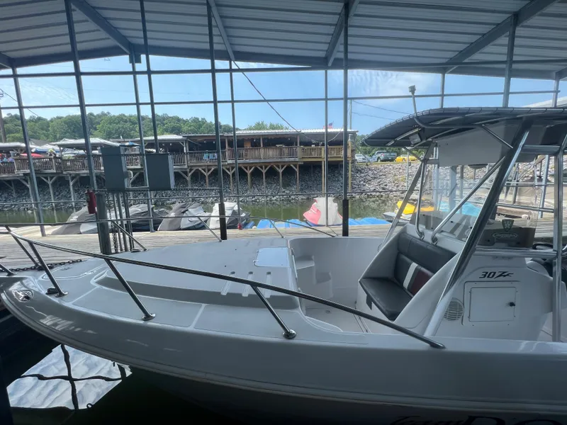 Slide: The Image of 1999 Donzi 30 ZF boat docked under a covered marina. - 36