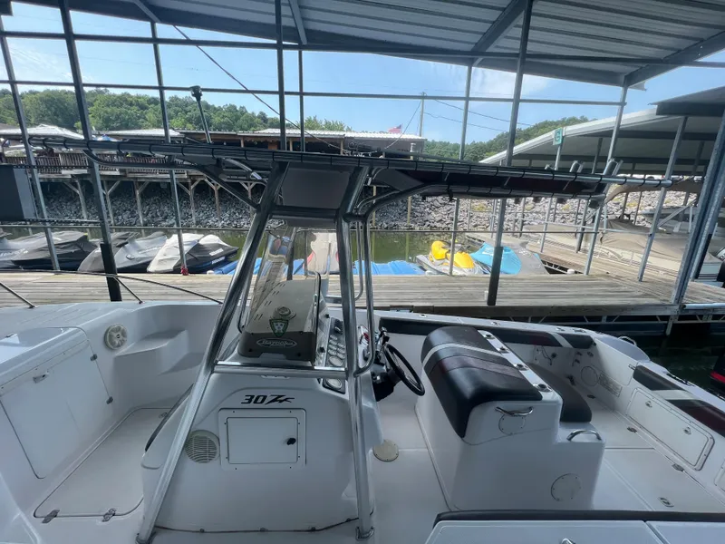 Slide: The Image of 1999 Donzi 30 ZF boat docked under a covered marina. - 38