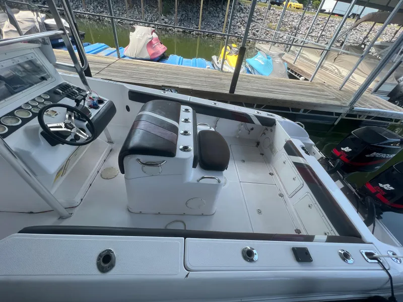 Slide: The Image of 1999 Donzi 30 ZF boat interior with helm and seating at dock. - 40