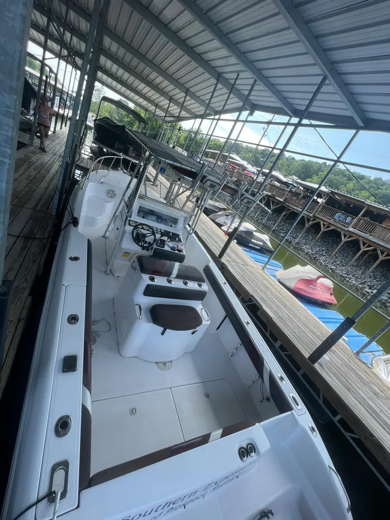 Slide: The Image of 1999 Donzi 30 ZF boat docked in a covered marina. - 41