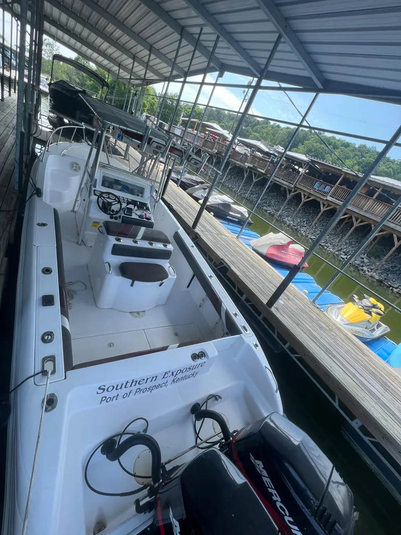 Slide: The Image of 1999 Donzi 30 ZF boat docked under a covered marina. - 42