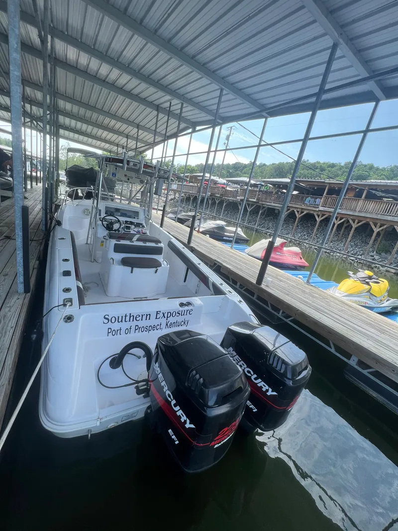 Slide: The Image of 1999 Donzi 30 ZF boat docked with twin Mercury outboard engines. - 43