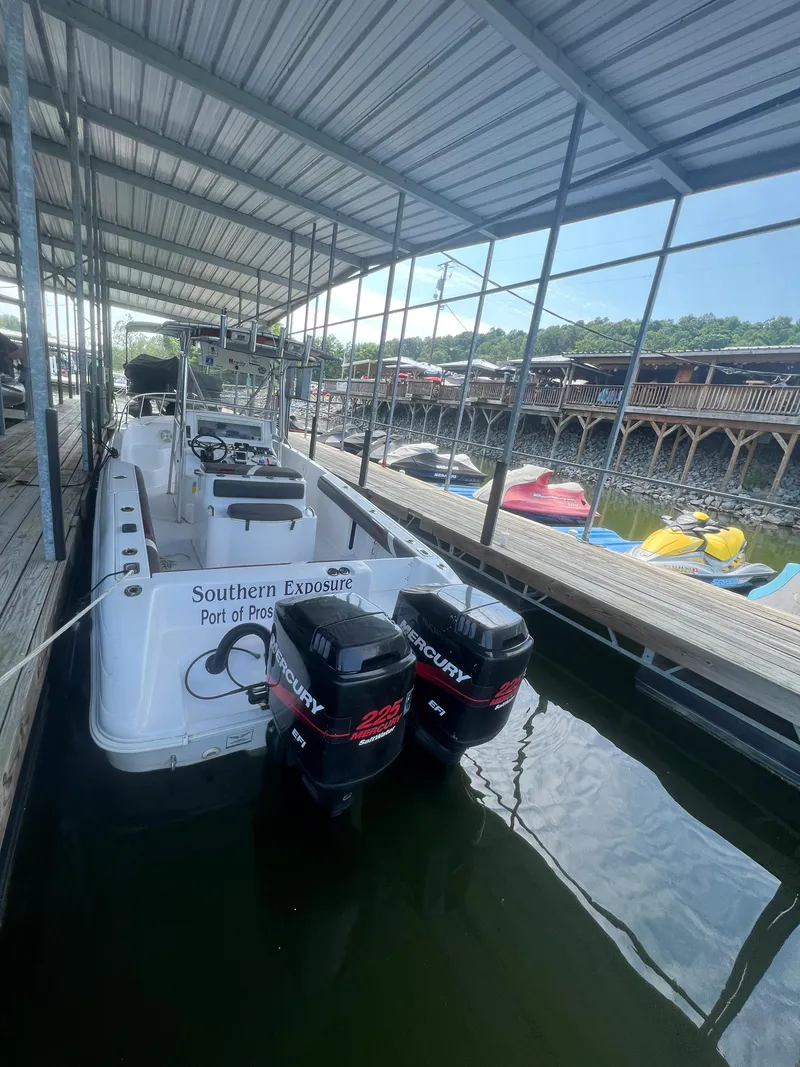 Slide: The Image of 1999 Donzi 30 ZF boat docked with twin Mercury outboard engines. - 44