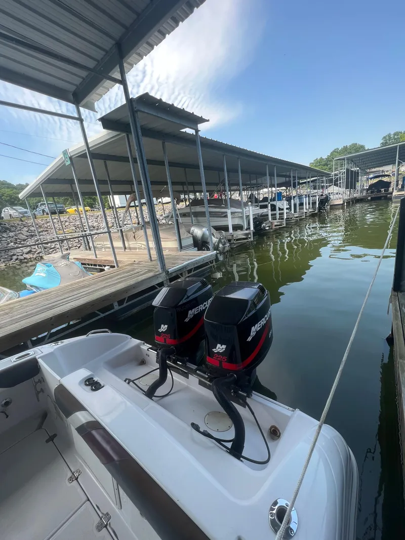 Slide: The Image of 1999 Donzi 30 ZF boat with twin Mercury outboard engines docked at a marina. - 45