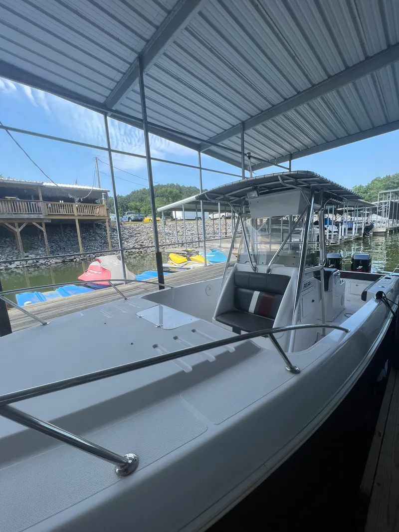 Slide: The Image of 1999 Donzi 30 ZF boat docked under a covered marina. - 46