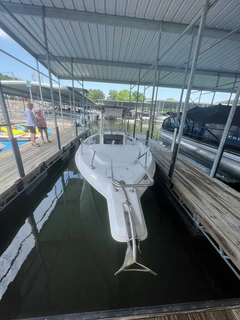 Slide: The Image of 1999 Donzi 30 ZF boat docked in a covered marina. - 48