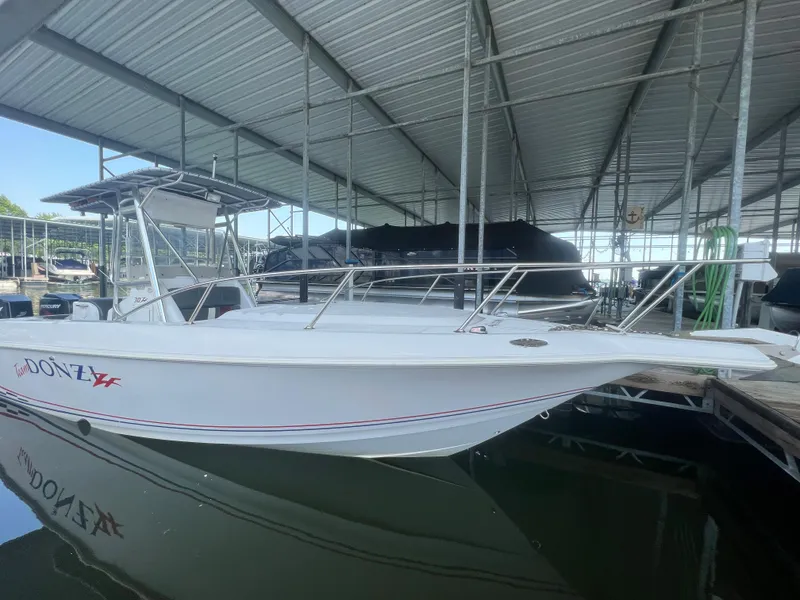 Slide: The Image of 1999 Donzi 30 ZF boat docked in a covered marina. - 49