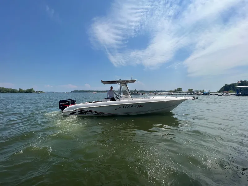 Slide: The Image of 1999 Donzi 30 ZF boat cruising on a sunny lake. - 6