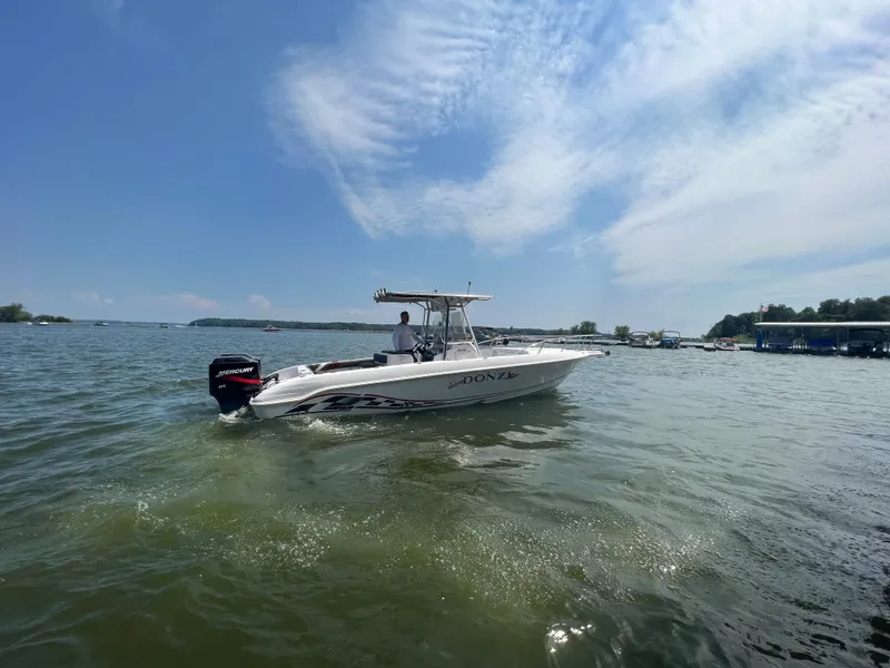 Slide: The Image of 1999 Donzi 30 ZF boat cruising on a sunny lake. - 8