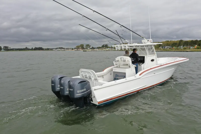 Slide: The Image of 2018 Buddy Davis 34 boat with triple Yamaha engines on the water. - 10