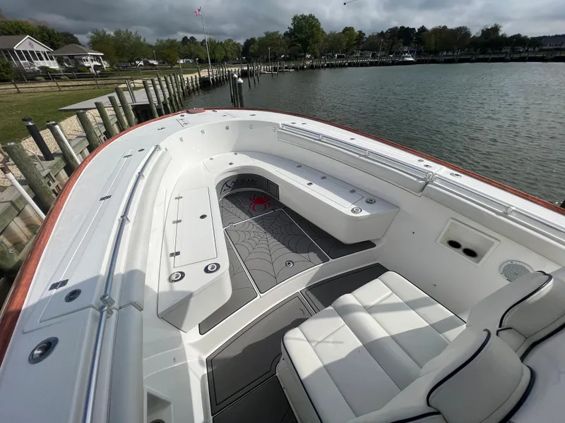 Slide: The Image of 2018 Buddy Davis 34 boat docked by a serene waterfront. - 14