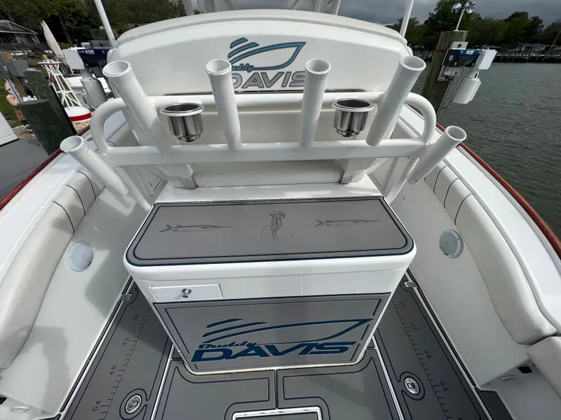 Slide: The Image of 2018 Buddy Davis 34 boat with rod holders and storage compartment. - 17