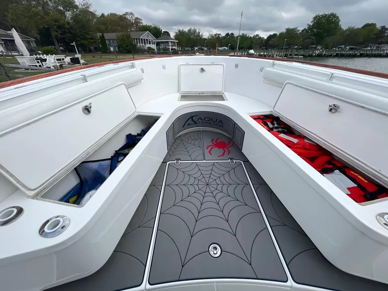 Slide: The Image of 2018 Buddy Davis 34 boat with open storage compartments and spider web design mat. - 19