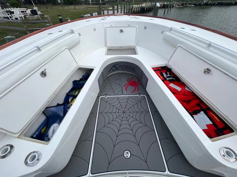 Slide: The Image of 2018 Buddy Davis 34 boat with open storage compartments and spider web floor mat. - 20