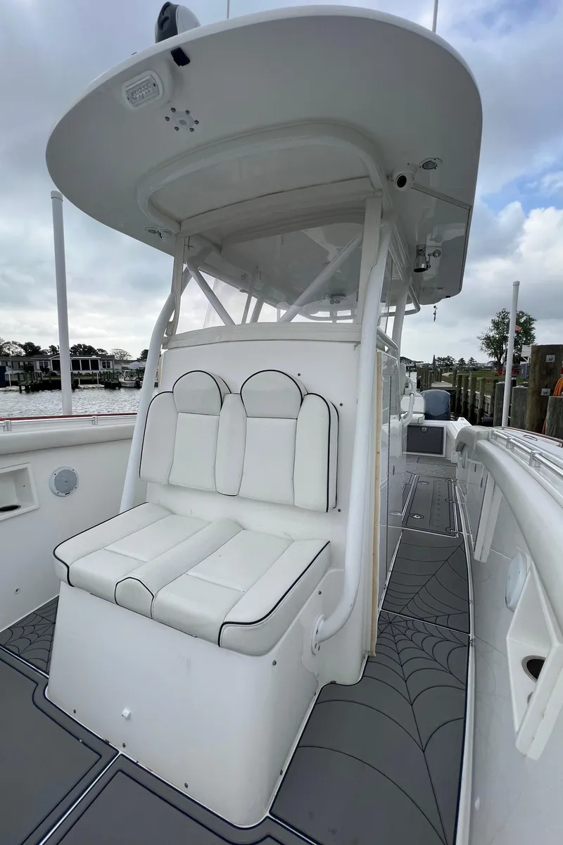 Slide: The Image of 2018 Buddy Davis 34 boat with white seating and canopy. - 25