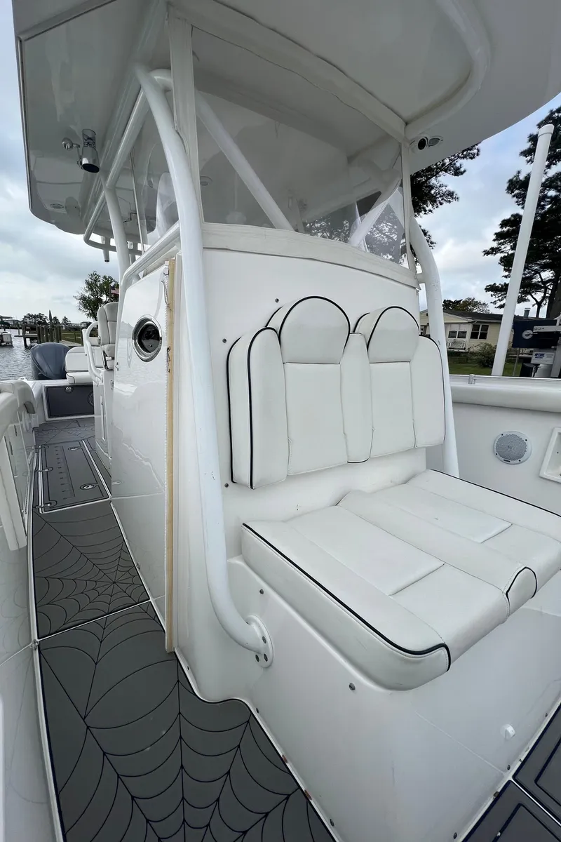 Slide: The Image of 2018 Buddy Davis 34 boat with white cushioned seating and modern design. - 26